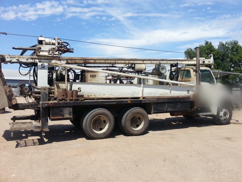 A water well drilling rig set up at a job site